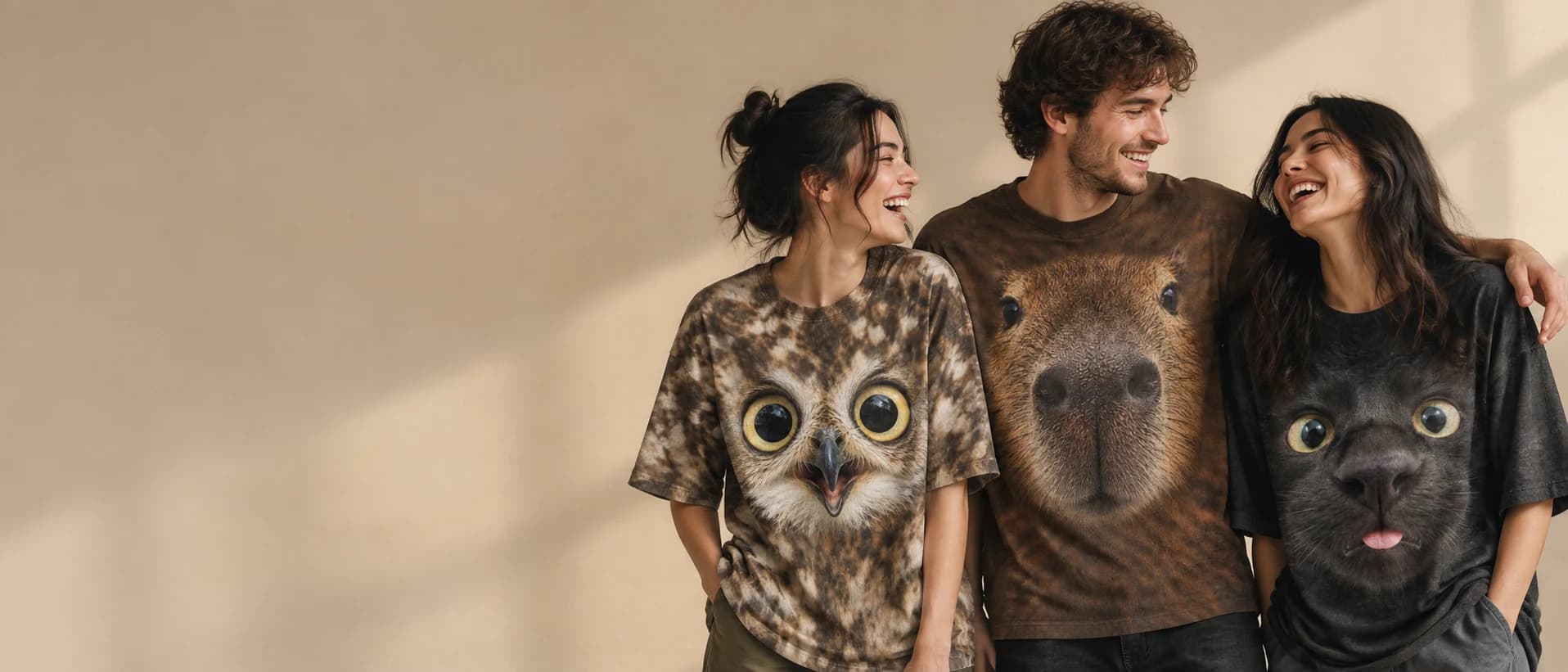 Three friends laughing in oversized 100% cotton T-shirts with giant owl, capybara and black cat face prints — Animal Face T-Shirts by allover.art